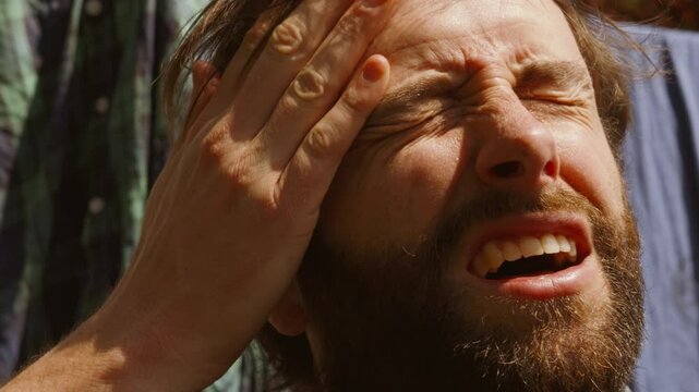 Young Bearded Man Rubbing Sweat Off Head During Summer Heatwave