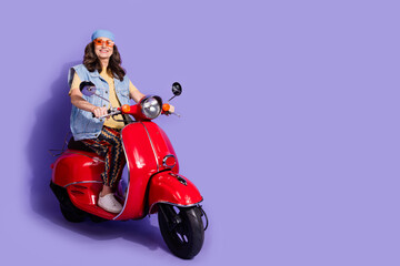 Full length photo of lovely pensioner lady ride motorcycle dressed stylish denim hipster garment isolated on purple color background