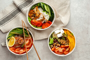 Beautiful composition with poke bowls on gray background with napkin