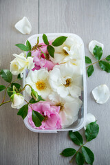 wooden light background with white and pink roses