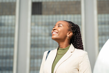 Confident Black Businesswoman Smiling Outdoors in Urban Setting - Powered by Adobe