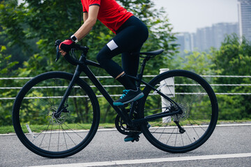 Fototapeta premium Asian woman cycling on summer trail