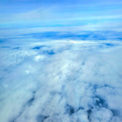 Snowy white clouds in the blue sky on a bright summer day big white clouds textured sky Scenery of fluffy white clouds Wide blue sky natural background.