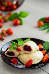 cooked sweet homemade steamed dumplings with strawberries