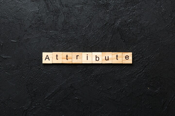 ATTRIBUTE word written on wood block. ATTRIBUTE text on cement table for your desing, concept
