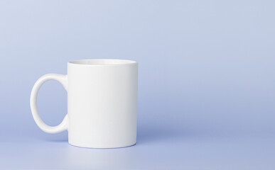 white cup for tea or coffee on a violet, purple background