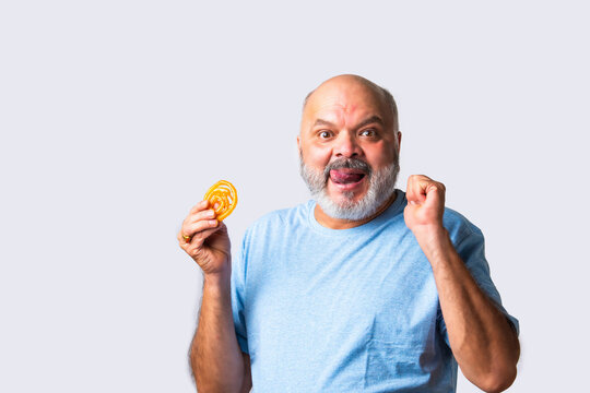 Asian senior matured elderly man eating jilapi or jalebi, a traditional indian sweet food