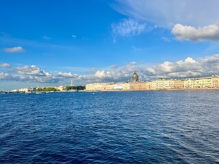Fototapeta premium Fantastic white clouds at the city river, city river view, summer day