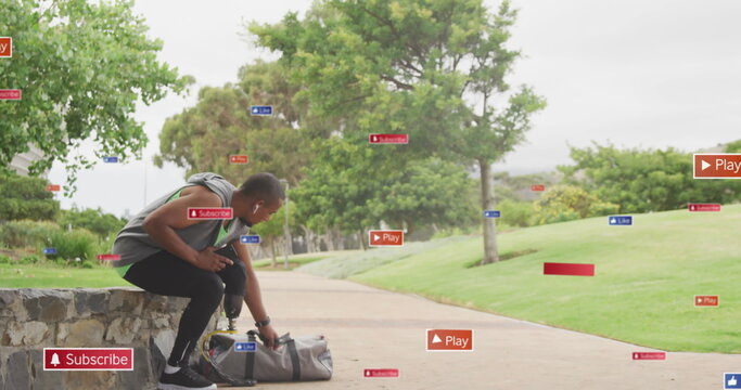 Image of notification icons over african american male athlete with prosthetic leg in park