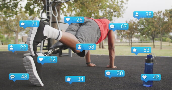 Image of social media icons with numbers, african american man with prosthetic leg doing plank