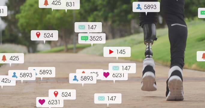 Image of notifications, low section of african american man with prosthetic leg jogging in park