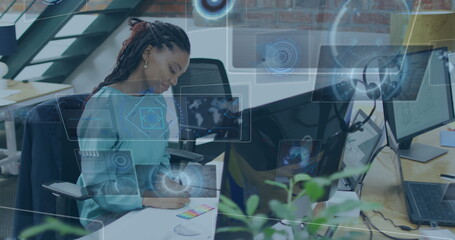 Image of financial data processing over biracial businesswoman in office