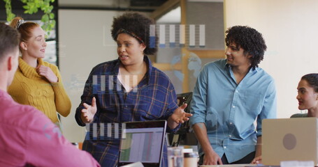 Image of financial data processing over diverse business people in office