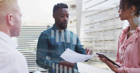 Image of financial data processing over diverse business people in office