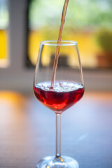 red wine pouring into glass