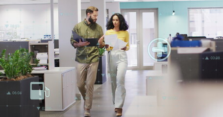 Image of digital icons over grid network against diverse man and woman discussing at office