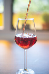 red wine pouring into glass