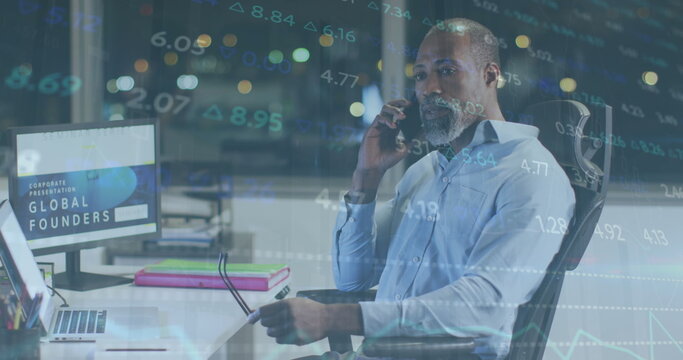 Image of stock market data processing over african american man talking on smartphone at office - Powered by Adobe