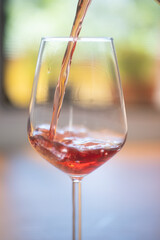 red wine pouring into glass