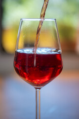 red wine pouring into glass