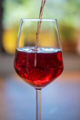 red wine pouring into glass