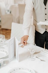 Elegant Dining Setup: Waiter Organizing Table
