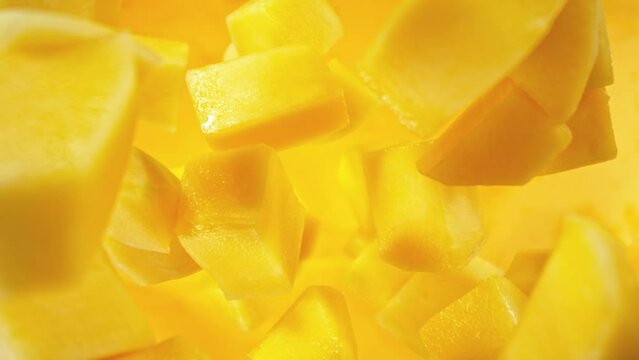 Super Slow Motion of Falling Mango Pieces into Water. Filmed on High Speed Cinema Camera, 1000fps, Placed on High Speed Cine Bot. Camera in Motion, Following Objects.
