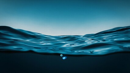 A stunning underwater panorama of the dark blue ocean surface, seen from a depth below
