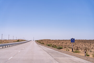 A road with a blue sign that says 
