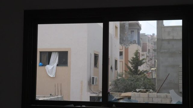 View from a destroyed house window to residential buildings and neighbourhood after missile attack in Rafah, Gaza Strip, Israel-Hamas war conflict