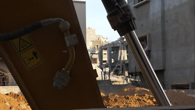 The symbol of a bulldozer ready to clear the rubble of a collapsed building in the city of Rafah, Palestine