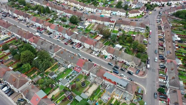 Aerial drone footage of the town of Dagenham, a district and suburban town in East London, England showing a typical British housing estates, roads and gardens from above in the summer time