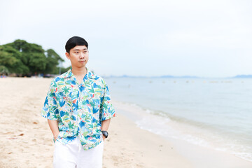 Portrait asian man tourism  happy smiling walking on the beach with beautiful ocean background copy space