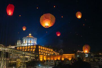 Festa de Sao Joao do Porto flying lanterns in Porto Portugal at st John's eve next to douro river bank Ponte Luis and Miradouro da Serra do Pilar