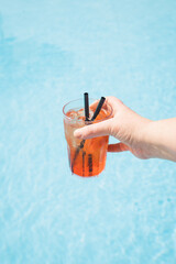 Refreshing Drink by the Pool: Aperol Spritz in Hand