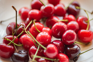 On the plate and the cherry in hand