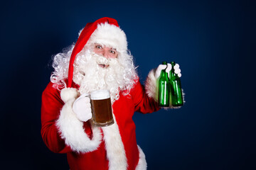Funny fat Santa Claus drinks beer on vacation.