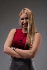 Young woman smiling with folded arms and head tilted