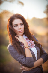 Fototapeta premium Autumn Beauty: Brunette Portrait Amidst Nature's Splendor