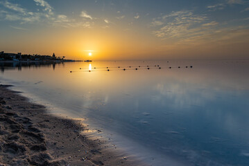 Sunrise on the sandy beach in Egypt with a boat