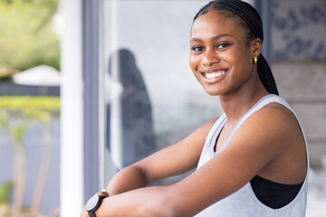 Smiling young woman leaning on railing, enjoying moment at home