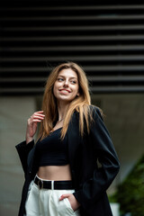 portrait of a beautiful girl in a business suit in the city