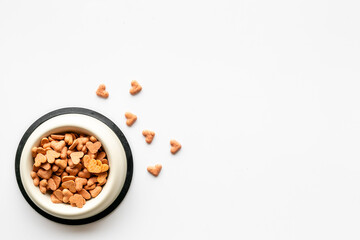 Food and treats for pets - biscuits in a shape of heart in a bowl