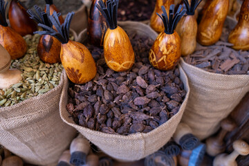 A variety of spices are displayed in wooden containers. The spices are in small bags and are arranged in a way that they are easy to see and access. Concept of abundance and variety