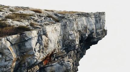 Fototapeta premium A person standing at the edge of a cliff with a scenic view