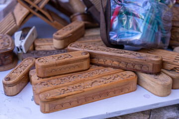 A pile of wooden items with some of them having designs on them. The pile is on a white surface