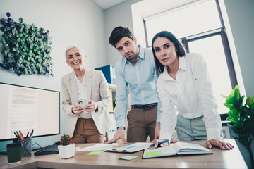 Photo of two employees mature boss woman discuss business plan minded collaborating new project office working together in modern workspace