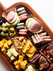 Raw ham, olives and cheese on a plate	