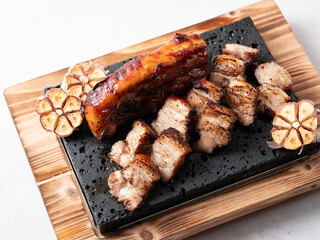 Oven-baked meat on a stone plate	