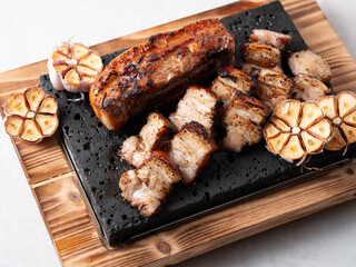 Oven-baked meat on a stone plate	